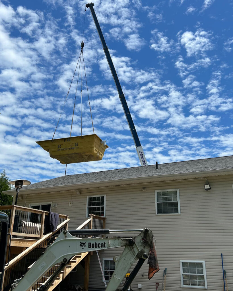 a fibreglass pool being delivered by crane